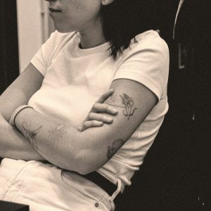 a woman sitting down with her arms crossed